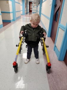 Photo of Timothy standing in his walker